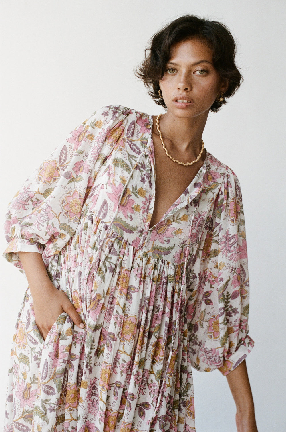 Daughters of India Kyra Maxi Dress in Fuchsia Bloom — studio close-up V-neckline, hand in pocket, gold necklace