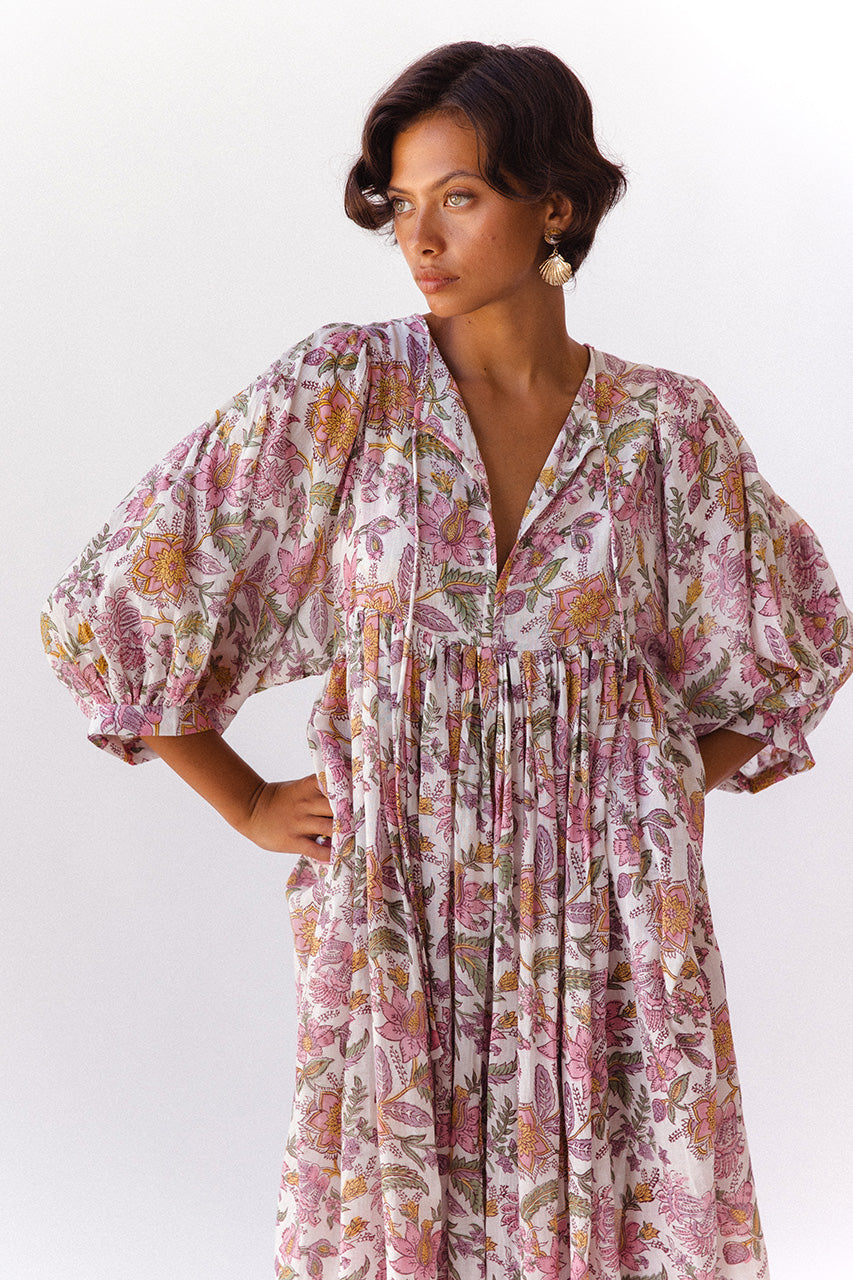 Daughters of India Kyra Midi Dress in Fuchsia Bloom — studio close-up V-neckline and billowed sleeves, floral print