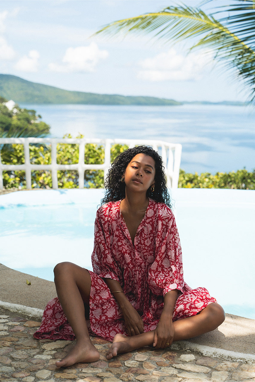 Daughters of India Kyra Midi Dress in Saffron — by tropical pool with palm trees, screen print